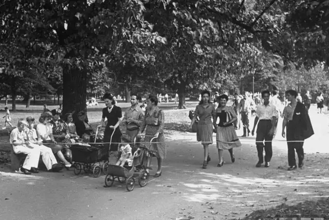 "Mothers pushing their babies in carriages as others stroll through Prospect Park." 1943